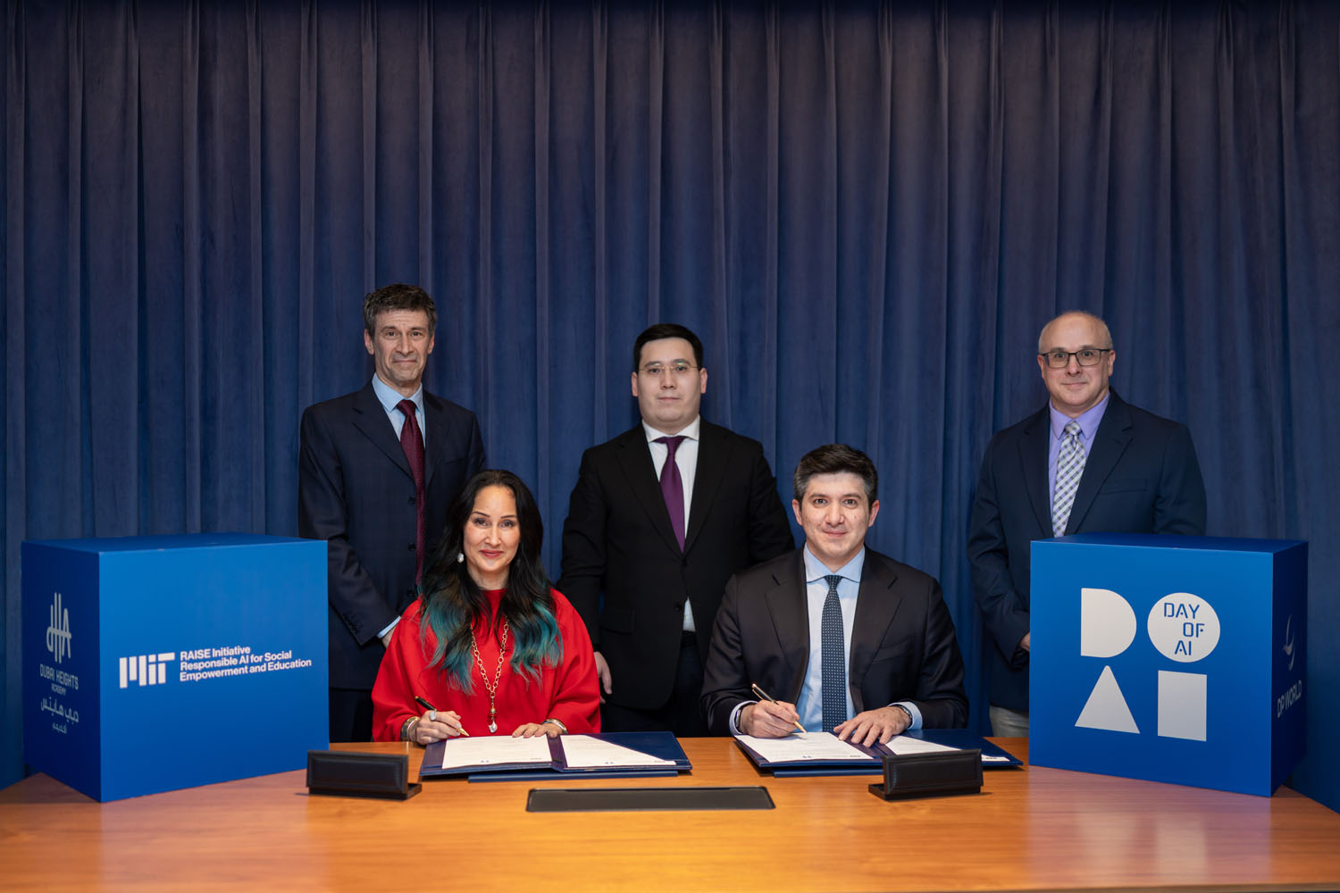 MIT RAISE Director Cynthia Breazeal (seated, left) and New Uzbekistan University First Vice-President for Academic Affairs Bahodir Ahmedov (seated, right) celebrate the formal expansion of Day of AI into Uzbekistan