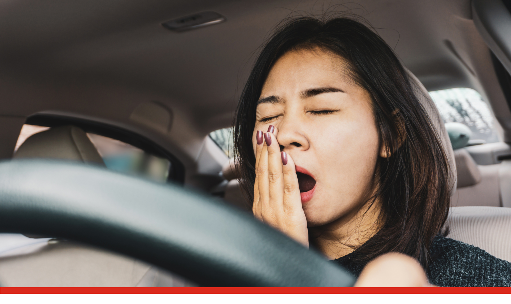 Woman yawning behind the wheel.png